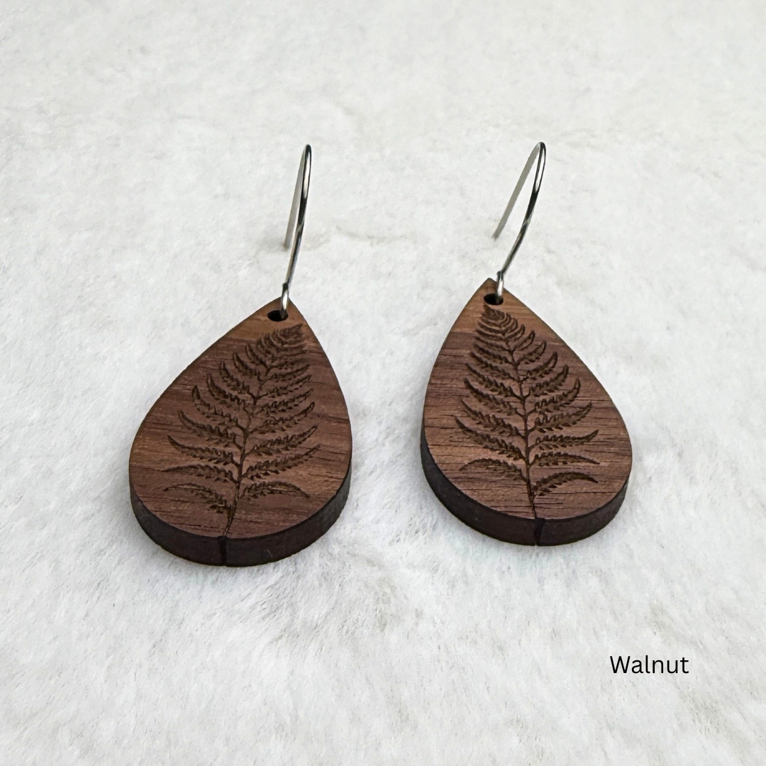 Fern leaf wooden earrings with stainless steel hooks. Finished with vegan wood oil. Laser engraved from walnut wood, handmade in Canada.
