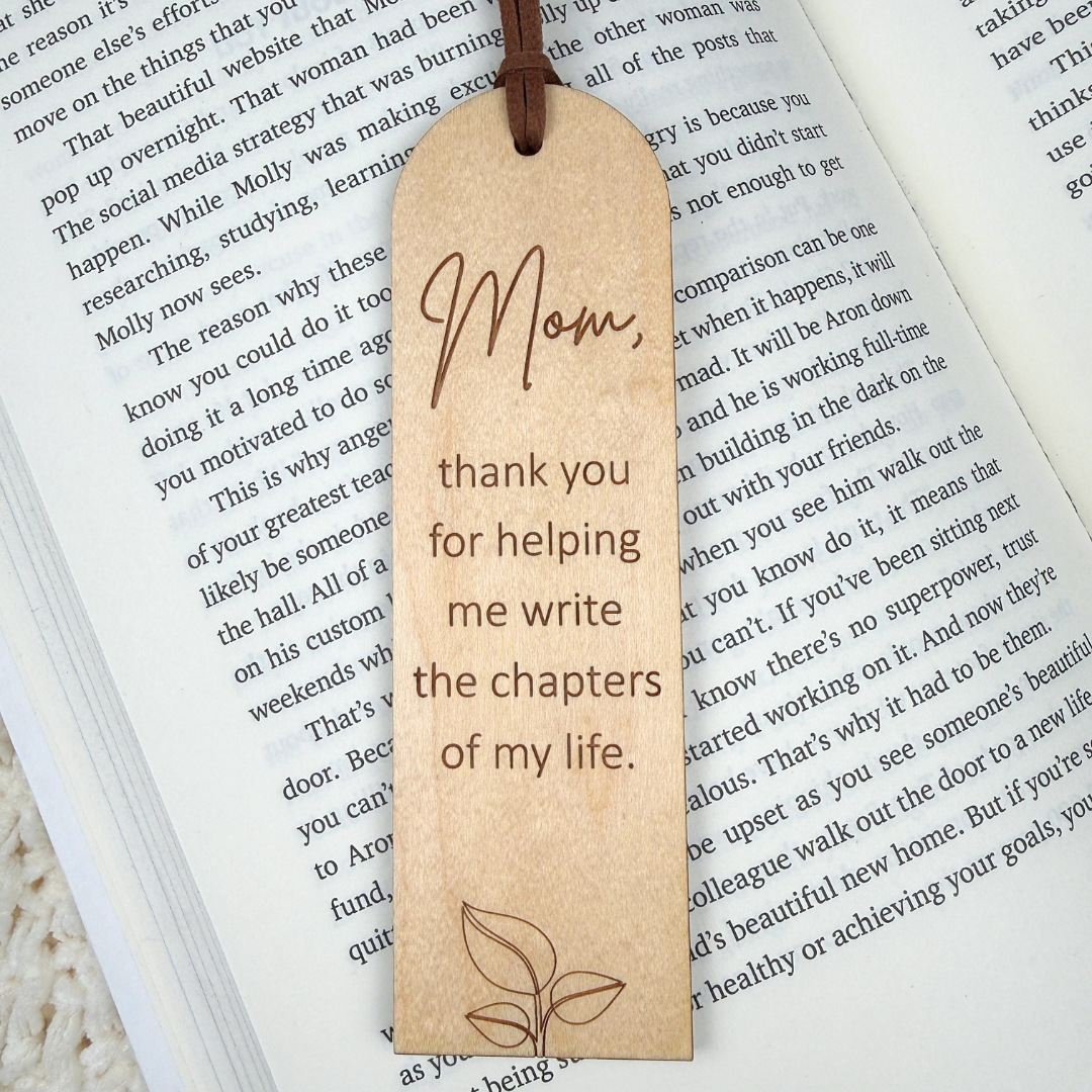 Wooden bookmark with engraved text on an open book