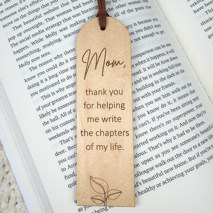 Wooden bookmark with engraved text on an open book