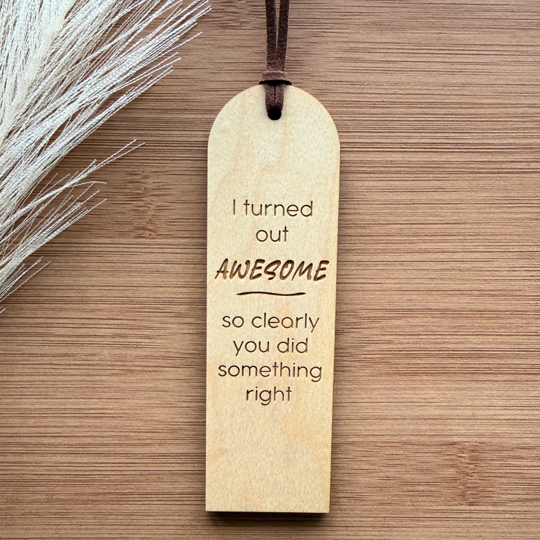 Wooden bookmark with humorous text on a wooden surface