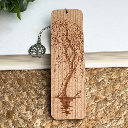 Wooden bookmark with tree design on a book, includes a silver tree pendant.