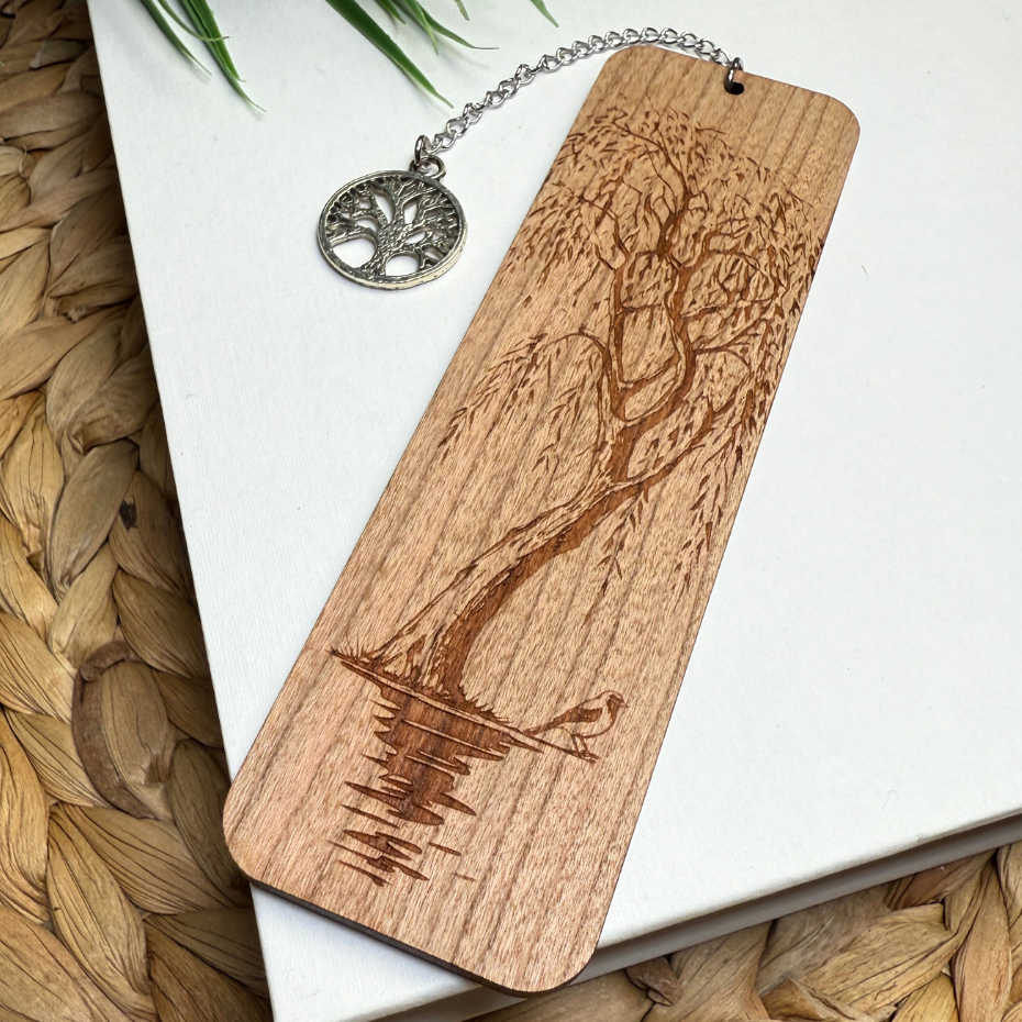 Willow tree bookmark with tree of life charm. Sitting on a white book
