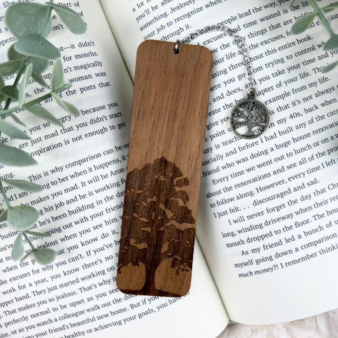 Wooden bookmark with engraved design on an open book