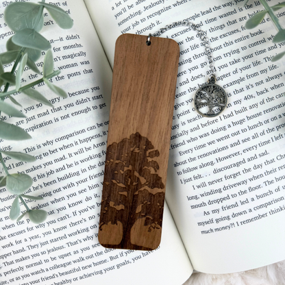 Wooden bookmark with engraved design on an open book