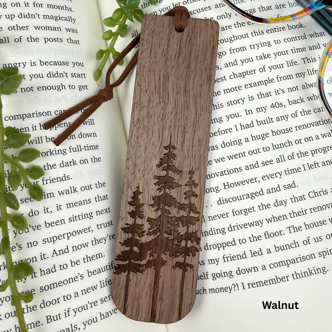 Wooden bookmark with tree engraving on a book page, walnut wood.