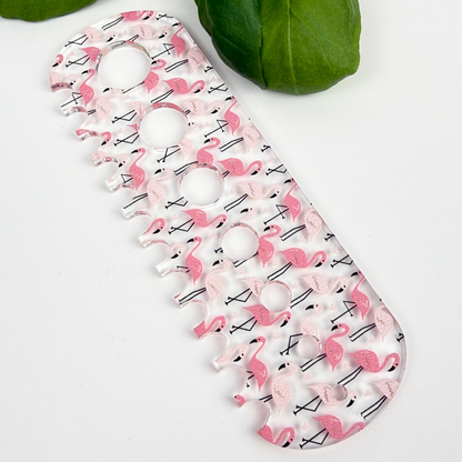 Pink flamingo herb stripper with 7 different hole sizes