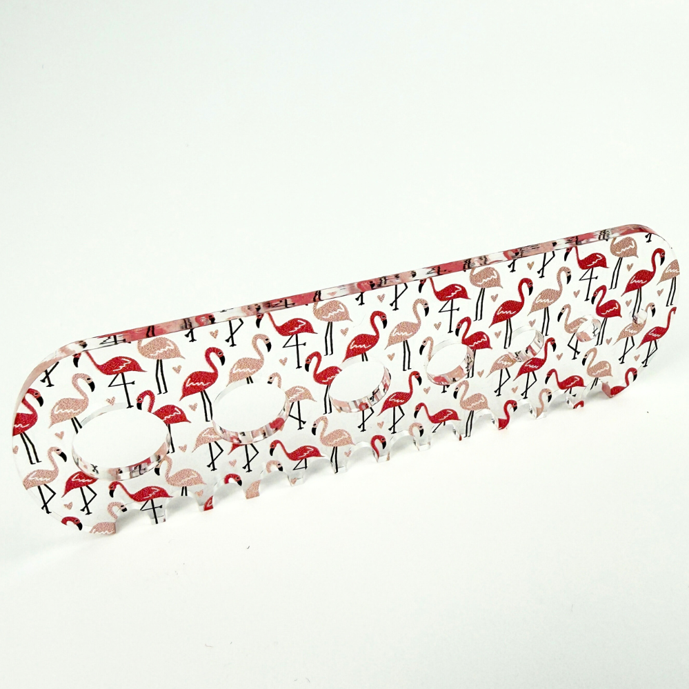 Pink flamingo herb stripper with 7 different hole sizes