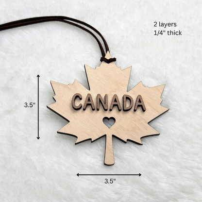 Canadian maple leaf wood ornament with dimension arrows and text showing 3.5" height and width, plus '2 layers 1/4" thick' in the upper right.