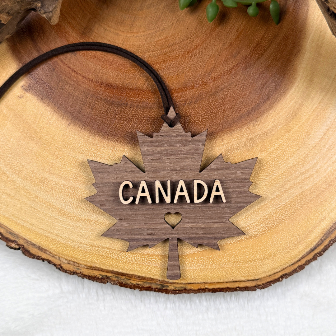 Canadian maple leaf hanging ornament handmade from walnut and maple wood in Ontario