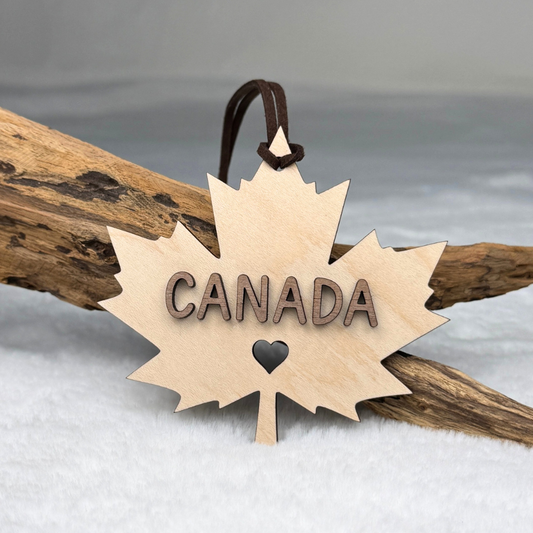 Canadian maple leaf wood ornament with raised walnut CANADA lettering