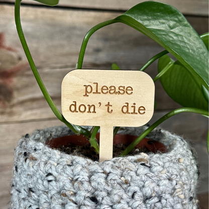 Wood plant sign for indoor plants in a potted plant.