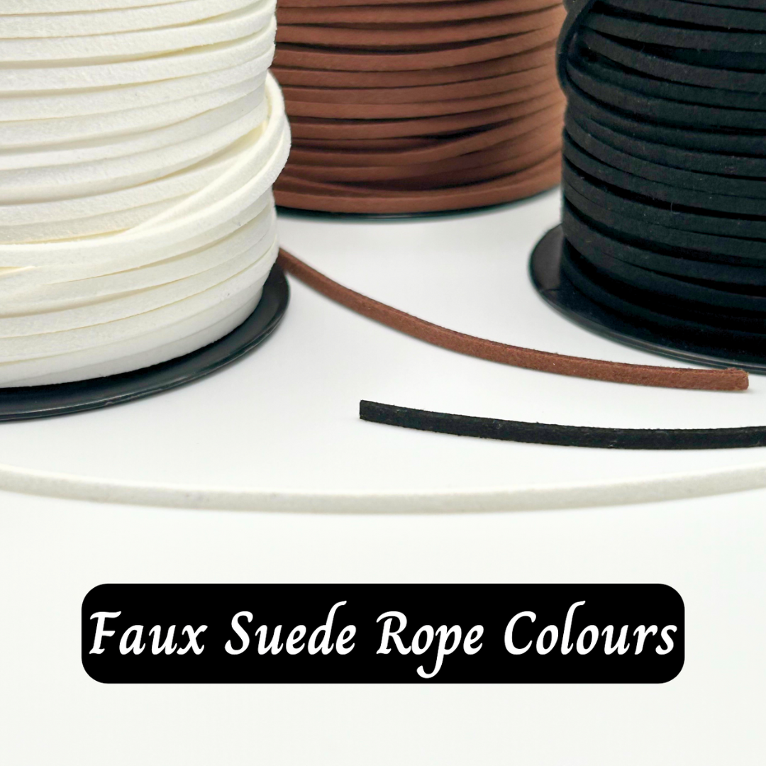 Spools of faux suede rope in white, brown, and black on a white surface.