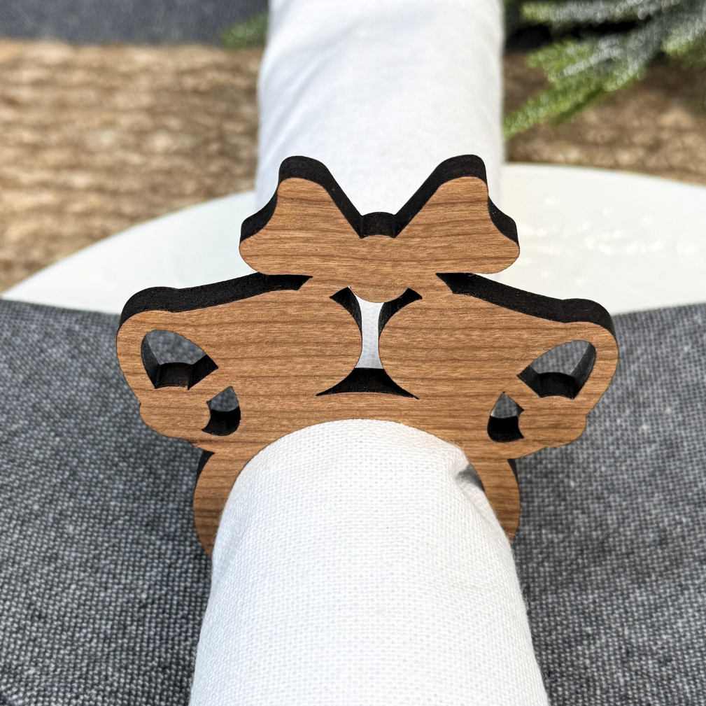 Wooden napkin rings in the shape of Christmas bells. Laser cut from cherry wood.