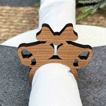 Wooden napkin rings in the shape of Christmas bells. Laser cut from cherry wood.