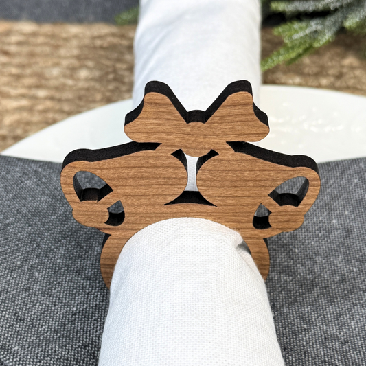 Wooden napkin rings in the shape of Christmas bells. Laser cut from cherry wood.
