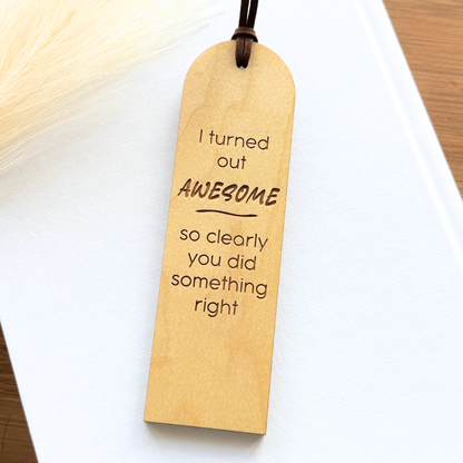 Wooden bookmark with humorous text on a white surface