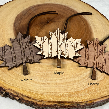 Walnut, maple and cherry Canadian maple leaf ornaments with engraved deer and birch forest design. Laser engraved and handmade.