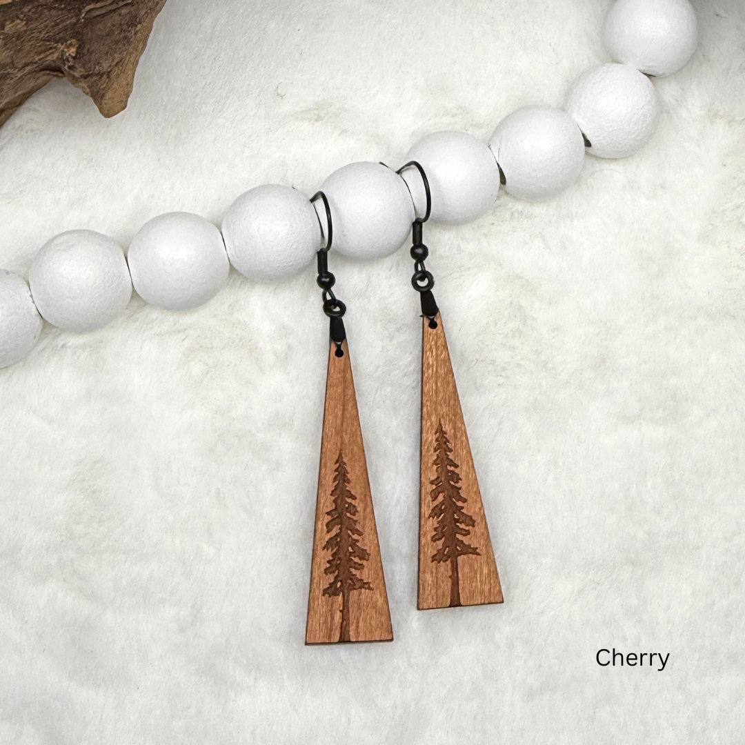Wooden earrings with an engraved tree design made from cherry wood and finished with vegan wood oil. Triangle shape with black stainless steel hooks.