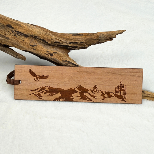 Mountain and eagle wooden bookmark with small Sasquatch (bigfoot) engraved on cherry wood with brown faux suede rope.