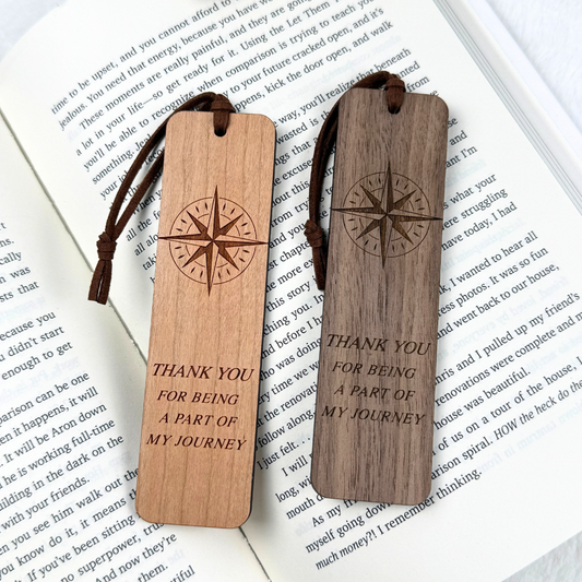 Compass wooden bookmark in walnut or cherry wood with appreciation quote, personalized with optional custom text on the back on open book pages.