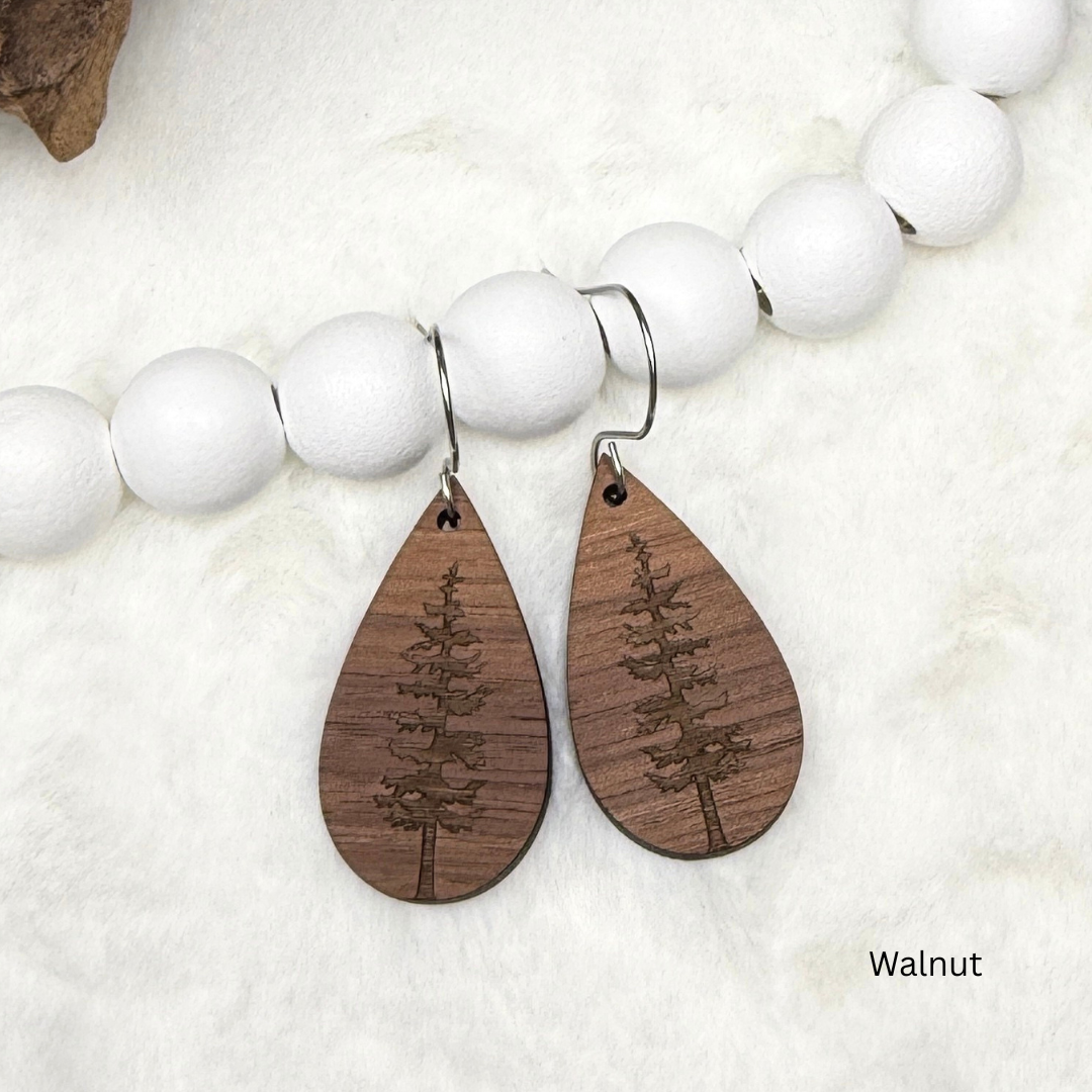 Wooden earrings with an engraved tree design made from walnut wood. Finished with vegan wood oil and stainless steel hooks. 