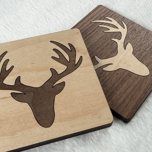 Close-up of maple and walnut deer inlay coasters showing the contrasting wood grain.
