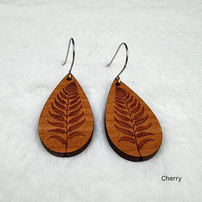 Fern leaf wooden earrings with stainless steel hooks. Finished with vegan wood oil. Laser engraved from cherry wood, handmade in Canada.
