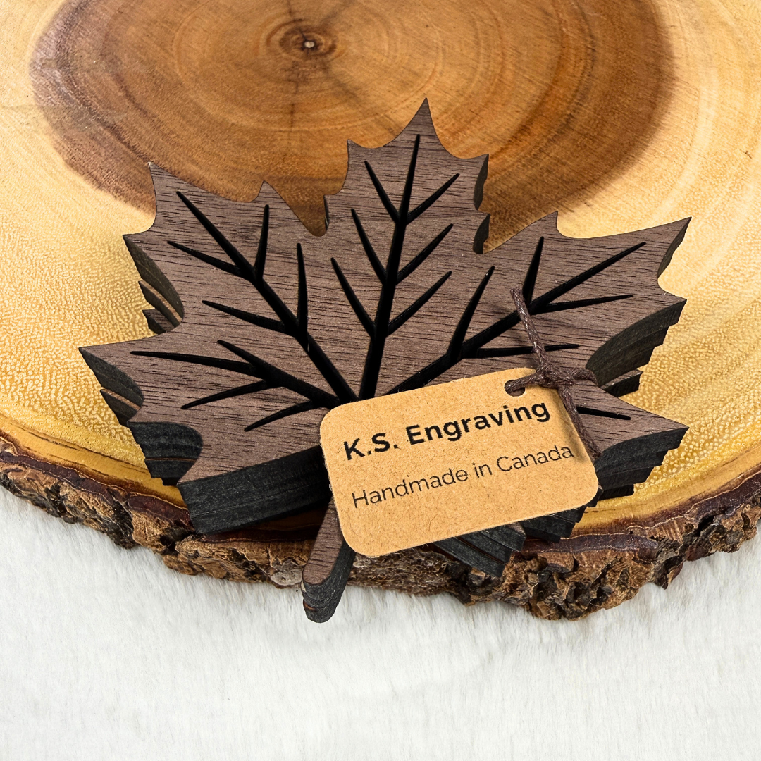 Set of four walnut maple leaf wood coasters packaged with K.S. Engraving Handmade in Canada tag