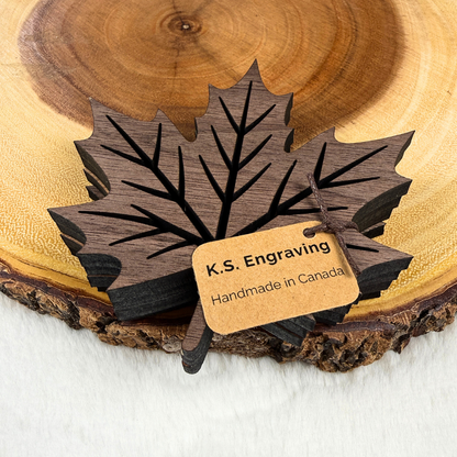 Set of four walnut maple leaf wood coasters packaged with K.S. Engraving Handmade in Canada tag