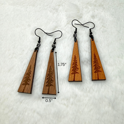 Wooden earrings with an engraved tree design made from walnut or cherry wood and finished with vegan wood oil. Triangle shape with black stainless steel hooks. Size is 1.75 inches by 0.5 inches.