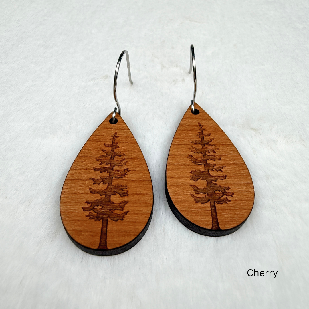 Teardrop shape wooden earrings with an engraved tree design made from cherry wood. Finished with vegan wood oil and stainless steel hooks.