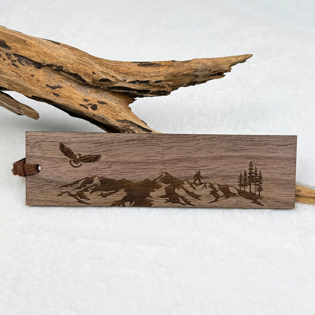 Mountain and eagle wooden bookmark with small Sasquatch (bigfoot) engraved on walnut wood with brown faux suede rope.