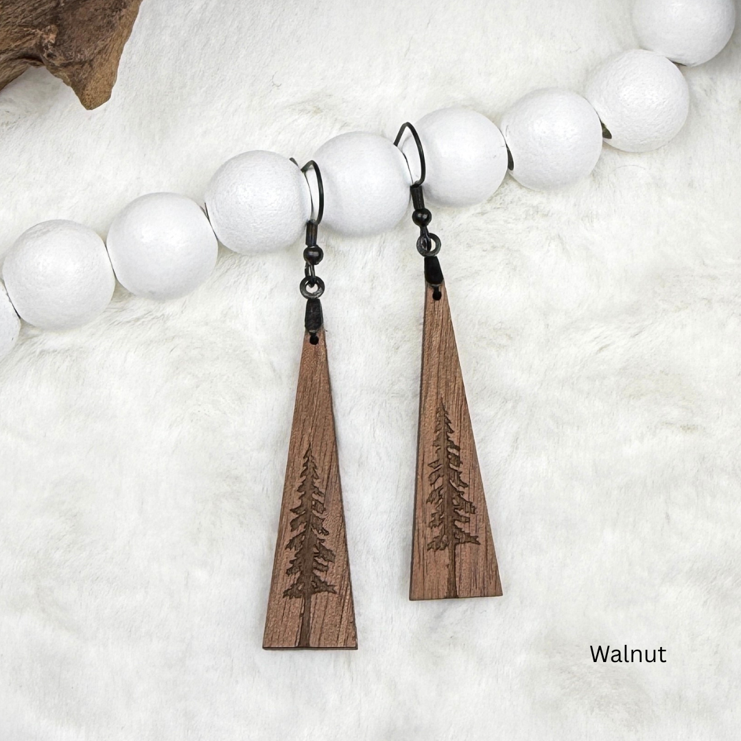 Wooden earrings with an engraved tree design made from walnut wood and finished with vegan wood oil. Triangle shape with black stainless steel hooks.