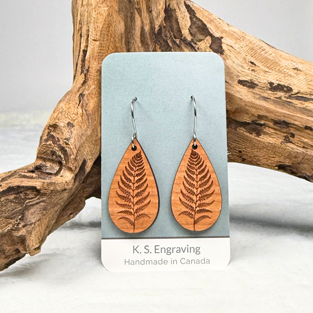 Fern leaf wooden earrings with stainless steel hooks. Finished with vegan wood oil. Laser engraved from cherry wood, handmade in Canada.