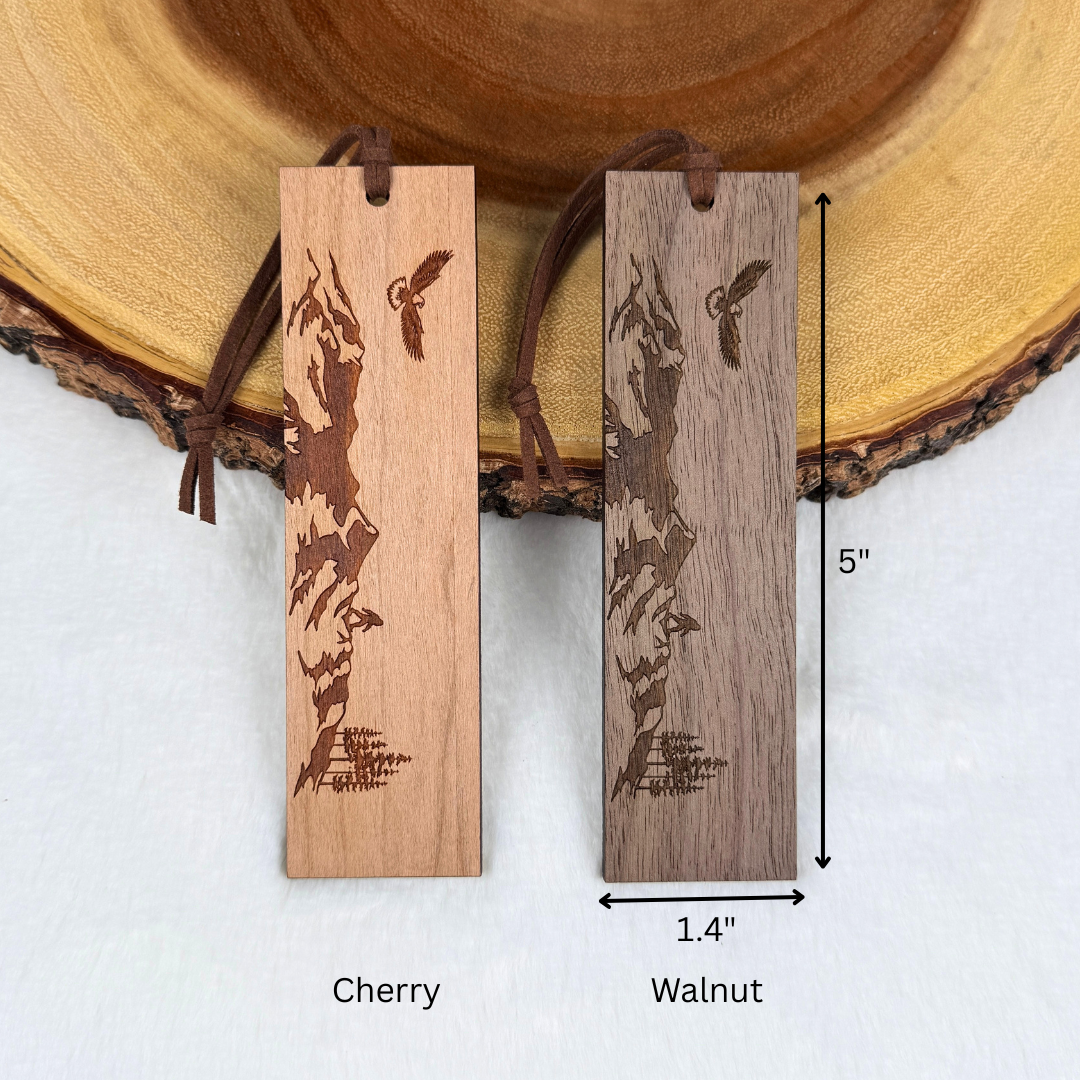 Cherry and walnut versions of the mountain and eagle wooden bookmark shown side by side with dimension arrows indicating 5 inches tall and 1.4 wide.