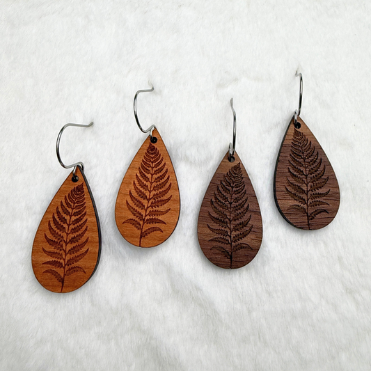 Fern leaf wooden earrings with stainless steel hooks. Finished with vegan wood oil. Laser engraved from walnut or cherry wood, handmade in Canada.