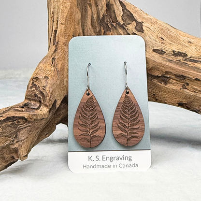 Fern leaf wooden earrings with stainless steel hooks. Finished with vegan wood oil. Laser engraved from walnut wood, handmade in Canada.