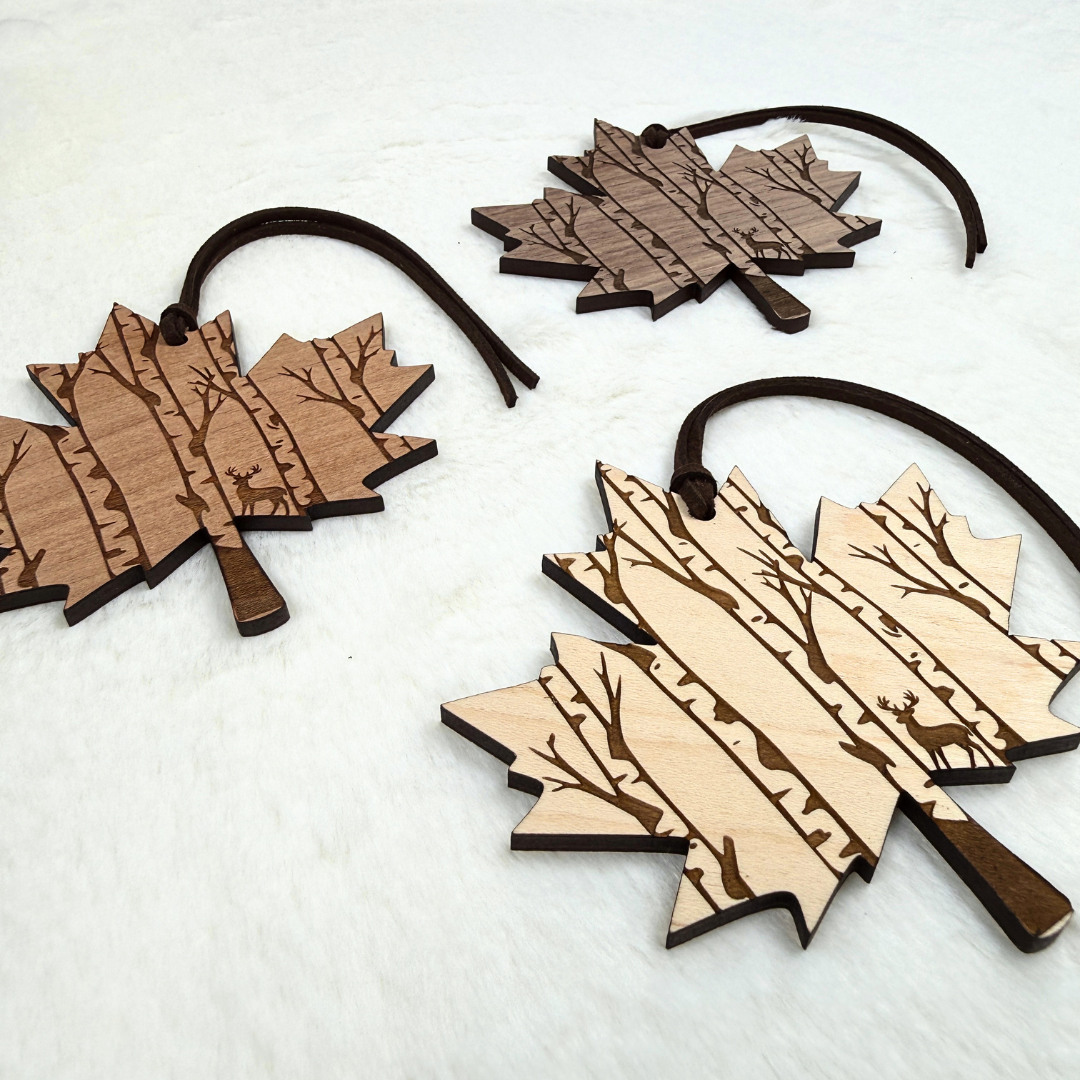 Canadian maple leaf ornaments in walnut, maple and cherry wood with brown faux suede hanging ropes
